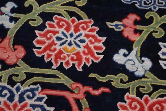 A Tibetan lotus rug, 5ft 6in. x 2ft 11in.